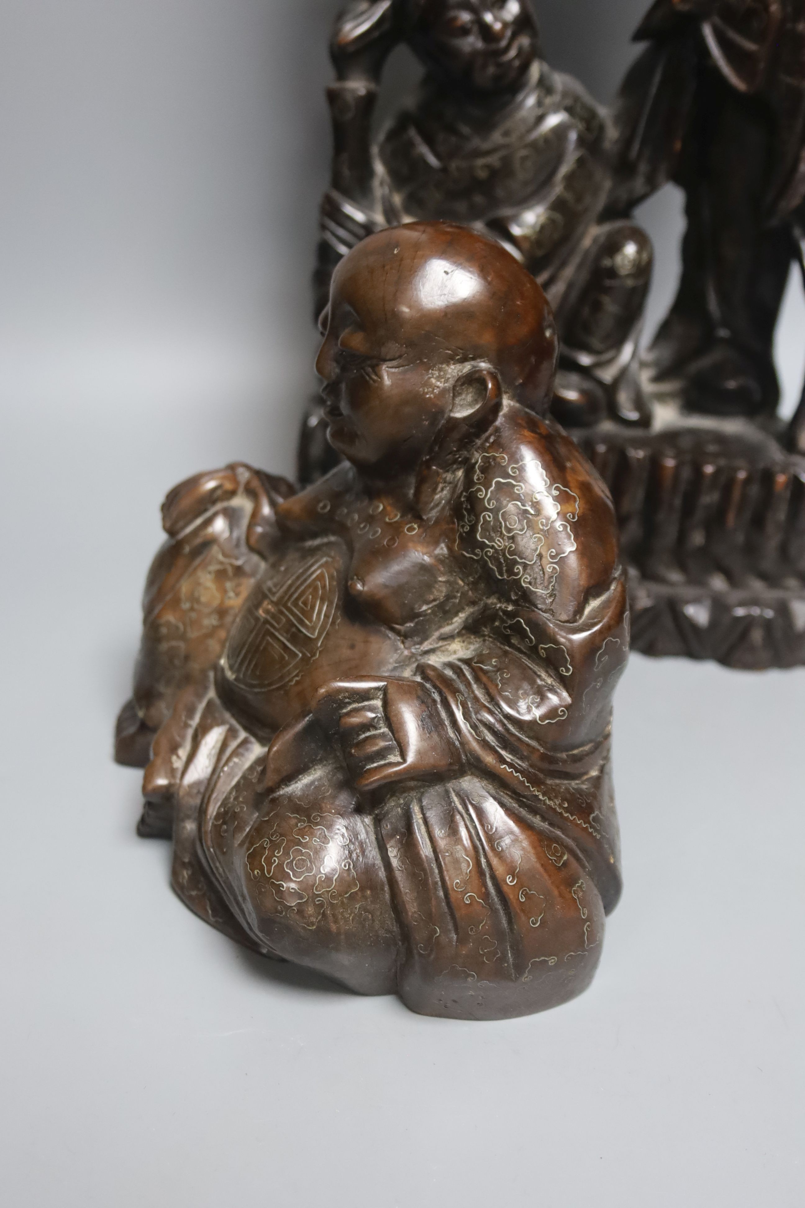 A Chinese hardwood and wire inlaid group of the He He Erxian and a similar figure of Budai, both early 20th century, tallest 49cm